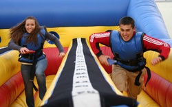 Boy and Girl Competing on the Bungee Run Course at a party in McDonough, Georgia